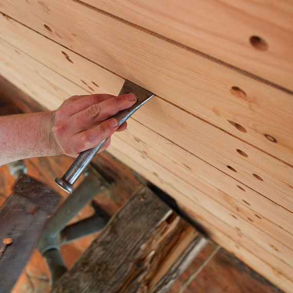 boat builder building a wooden boat