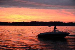 fishing from a boat at sunset, on an Indiana Lake