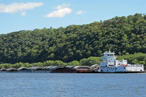 tugboat and barges on the Mississippi River between Iowa and Wisconsin