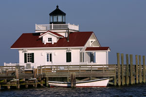 Manteo lighthouse and dory in Albemarle Sound