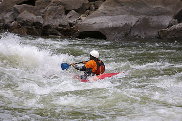 kayaker navigating rapids on a West Virginia river