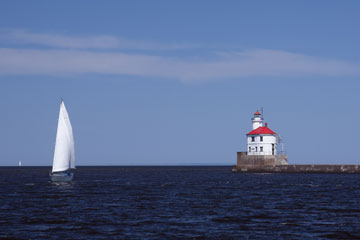lighthouse and sailboat at Wisconsin Point on Lake Superior